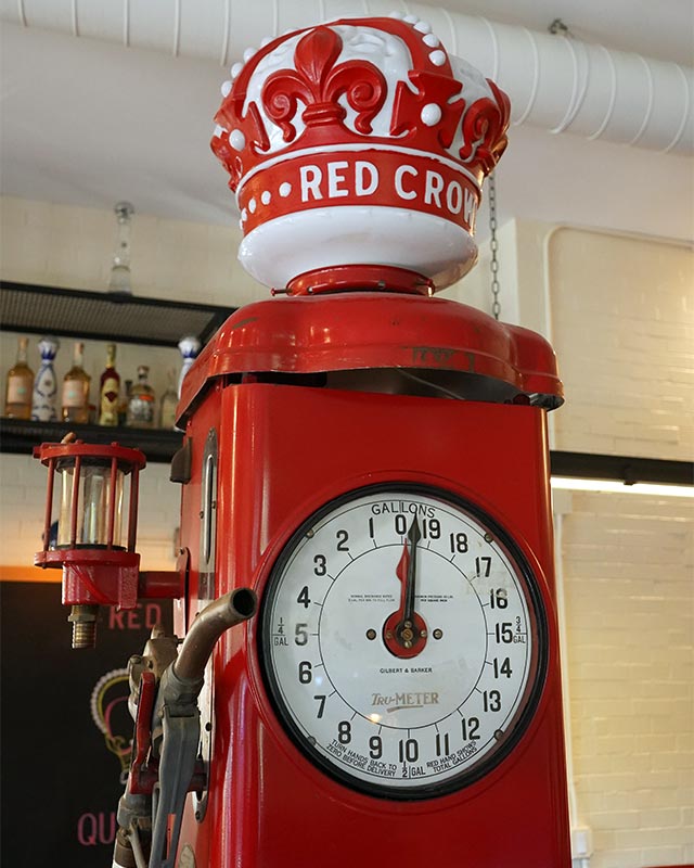 Vintage red gas pump decor at Red Crown sports bar in Grosse Pointe Park, setting the scene for burgers and happy hour