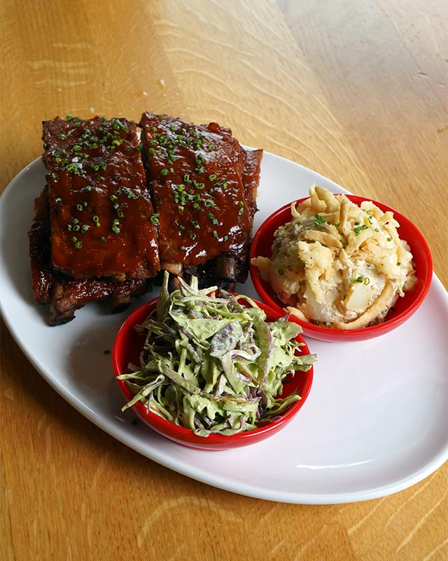House-smoked ribs with mac and slaw at Red Crown, a local sports bar for hearty plates, burgers, and happy hour