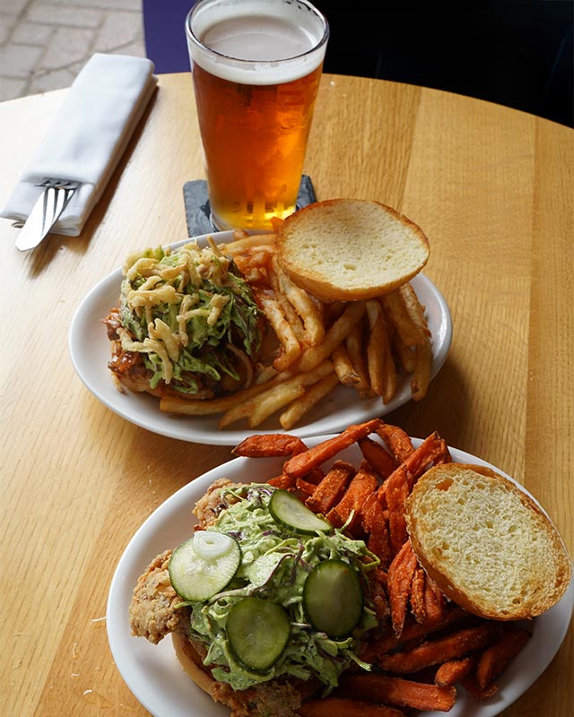 Classic burgers with fries and a pint at Red Crown sports bar, perfect for happy hour in Grosse Pointe Park