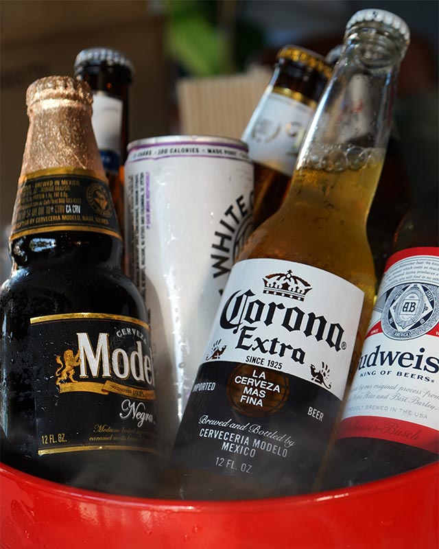 Ice-cold beer bucket featuring Modelo, Corona, and Budweiser for happy hour at Red Crown sports bar